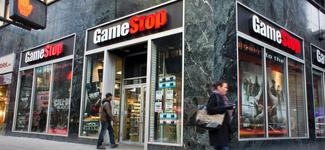 <p>Two pedestrians on a sidewalk in front of a GameStop store</p>
