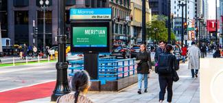 <p>A number of people walking on a sidewalk near a screen run by Intersection. These screens will be selling ad space programmatically via Broadsign Reach.</p>