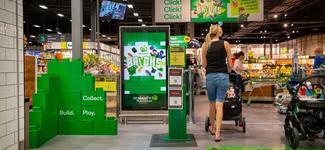 <p>An image of a shopper walking past a digital display operated by Cartology and running on Broadsign software</p>

