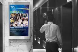 Executive Channel Network screen near office building elevator.